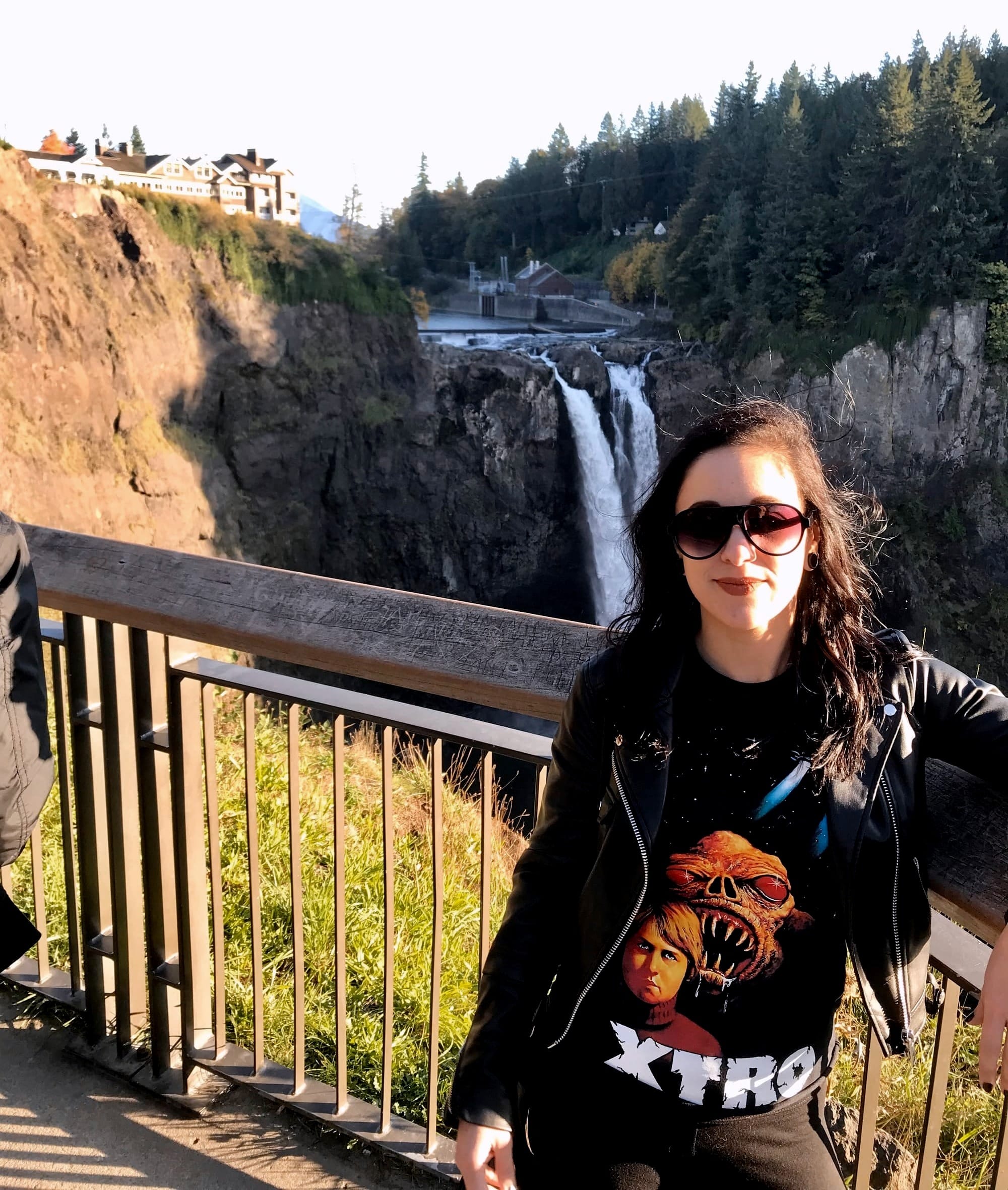 Yasmina standing outside overlooking the Great Northern Hotel and a waterfall from the show Twin Peaks.